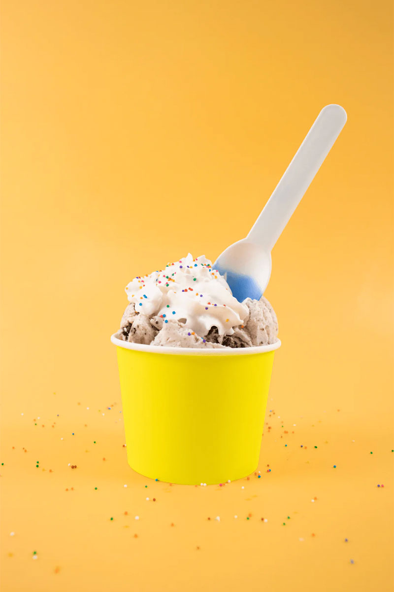 white to blue color changing spoon in yellow ice cream cup